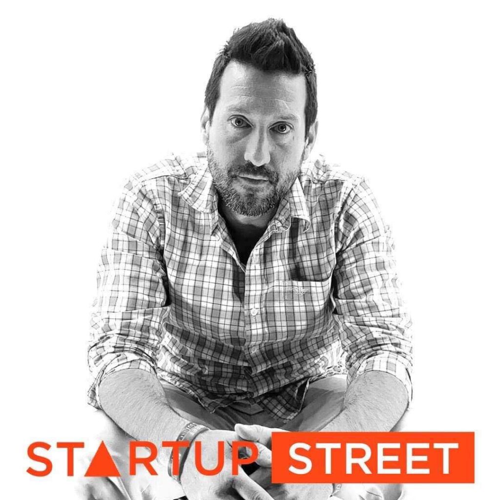 Owner of Startup Street sitting down and looking into the camera in a black and white image