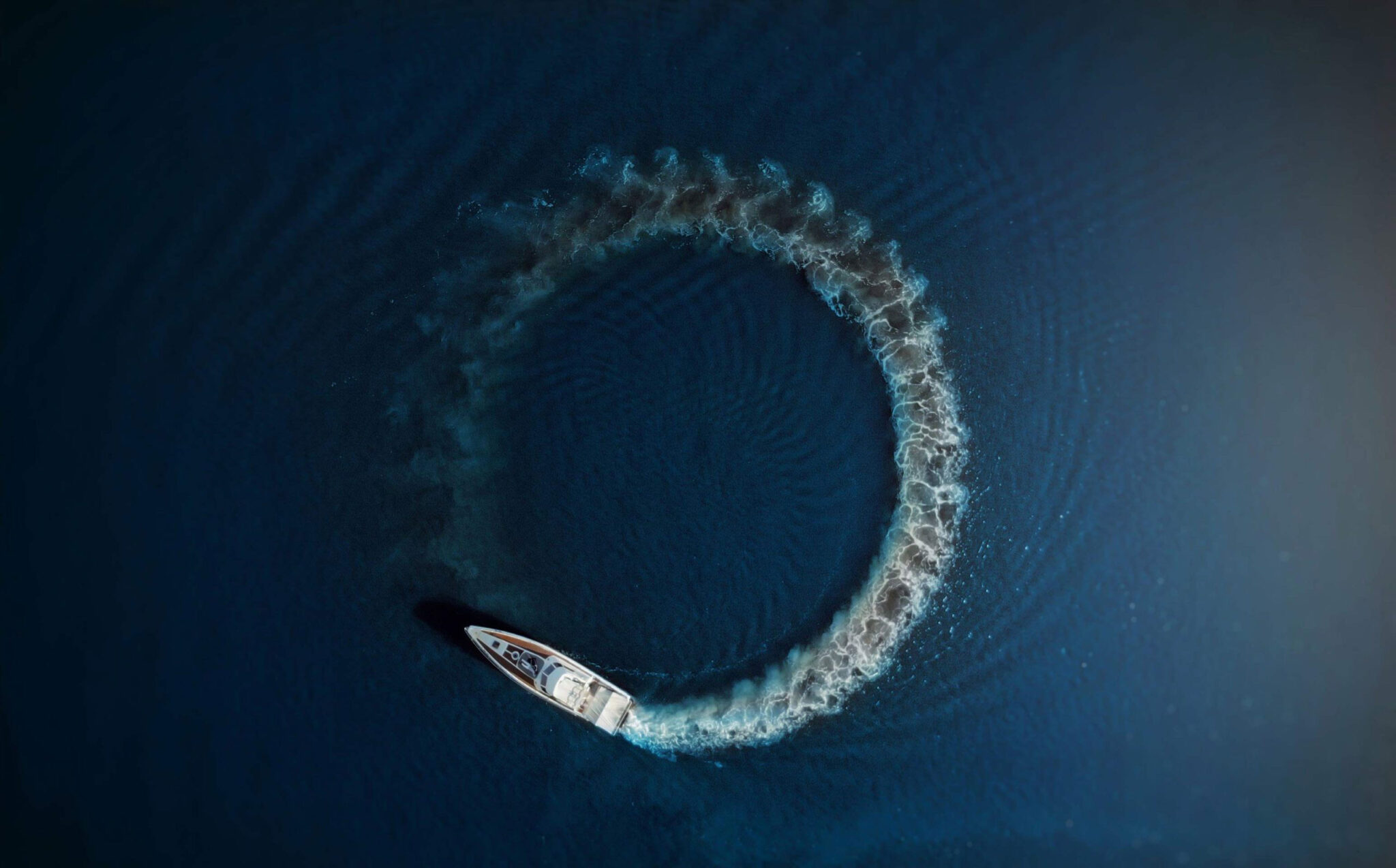 Tampa Website Design branding image of a boat circling from an overhead drone shot.