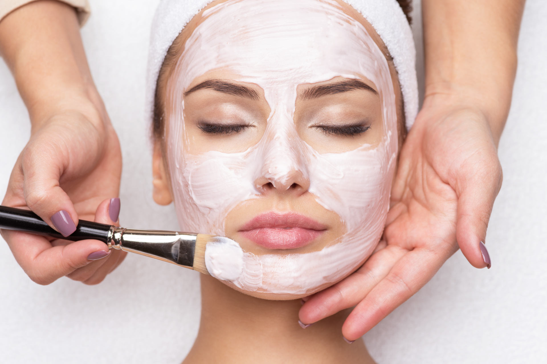 Woman getting a facial for a web development image used in branding for Skin Science